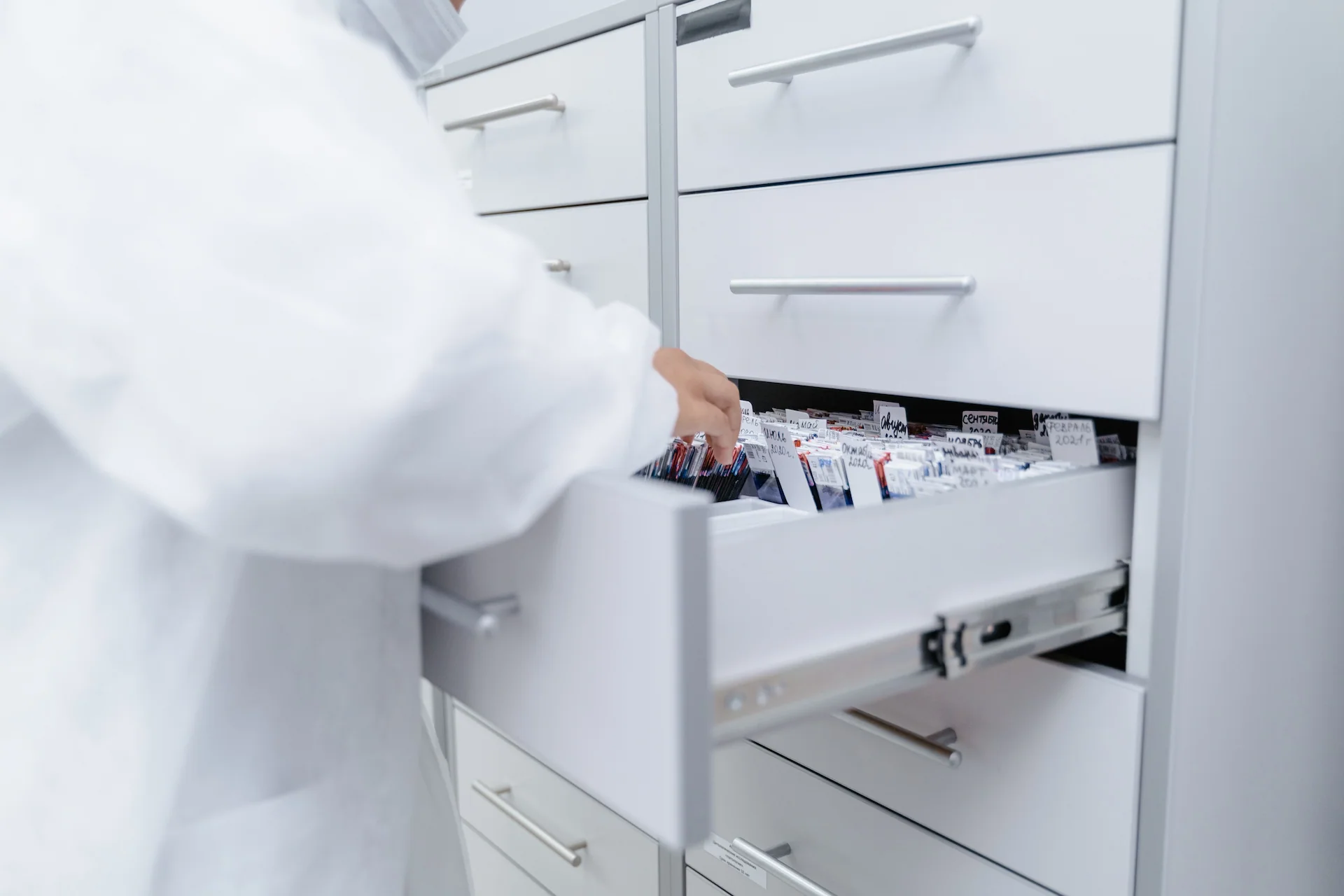 OIKOS laboratory worker taking documentation from an archive drawer