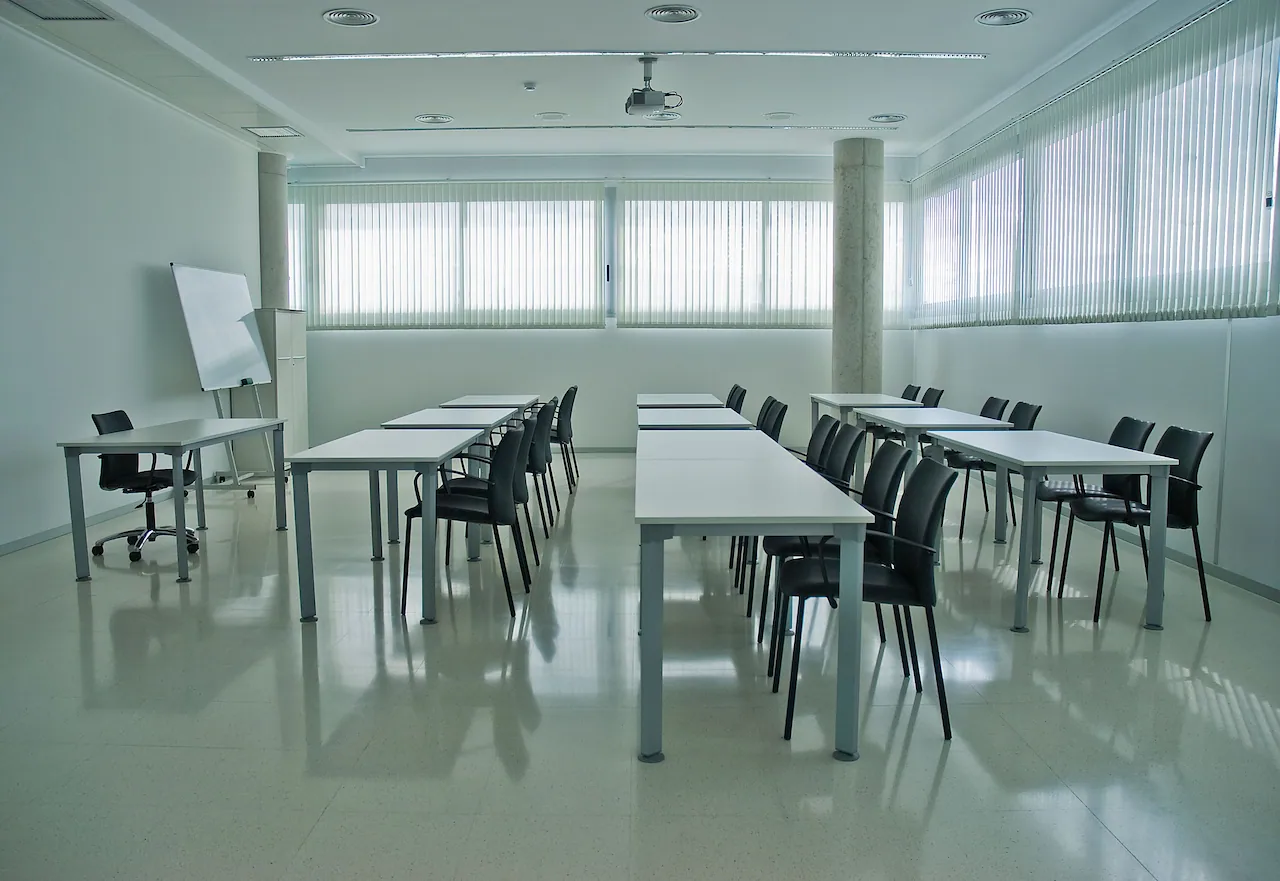 OIKOS training room set up for training with a whiteboard and participant seating